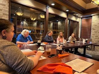 People sat round a table having a meeting